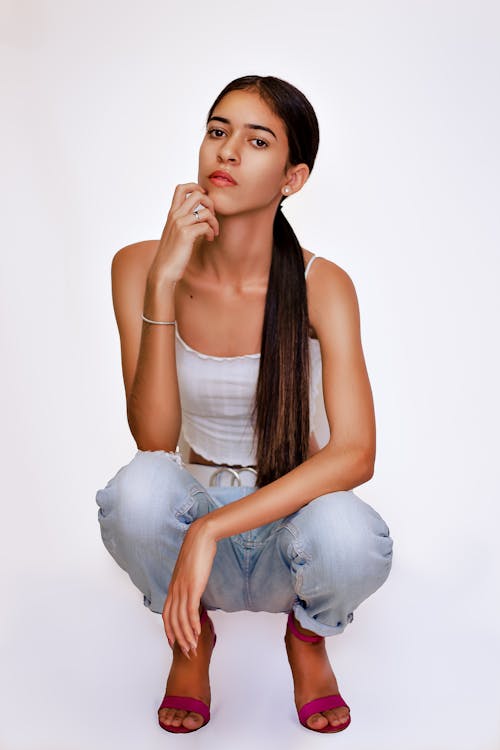 Model Crouching in Jeans