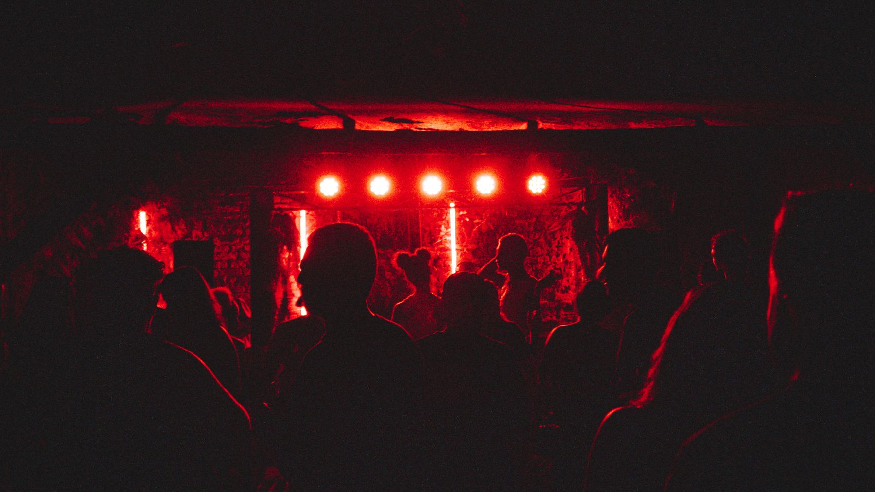 Crowd under rig lights, monochrome feed