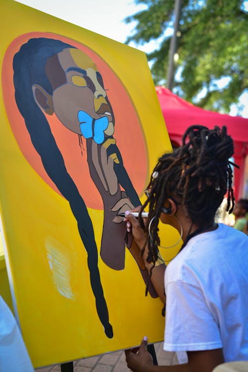 A Woman Painting a Woman's Face