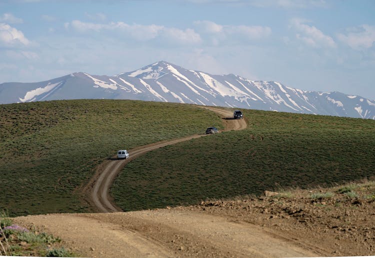 Trucks On A Dirt Road In The Hills