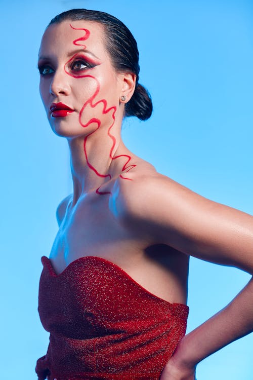 Portrait of a Woman in Red Dress with Red Makeup