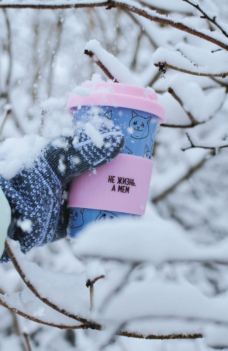 Hand Holding A Thermal Mug In Winter