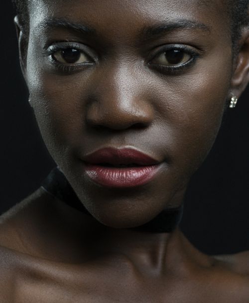 Free Intimate close-up portrait of a beautiful black woman with a serious expression. Stock Photo