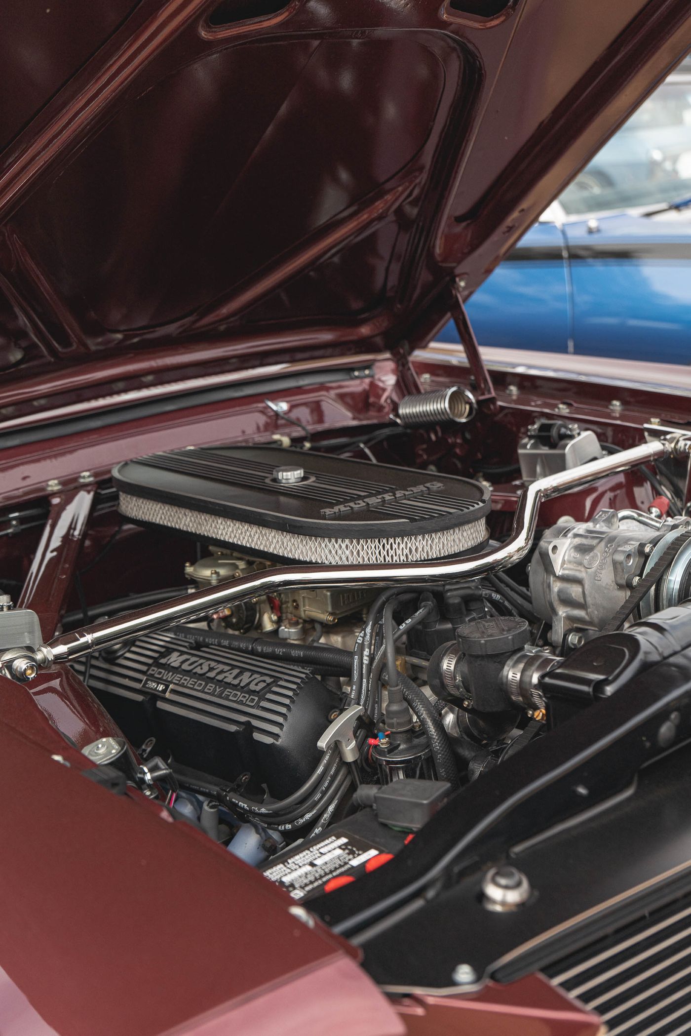 Close-up of a car engine bay under an open hood