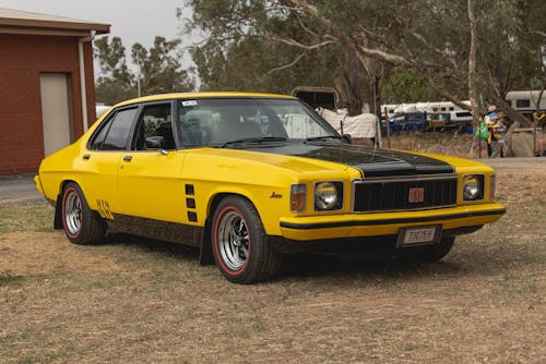 Yellow Retro Car Parked on Grass