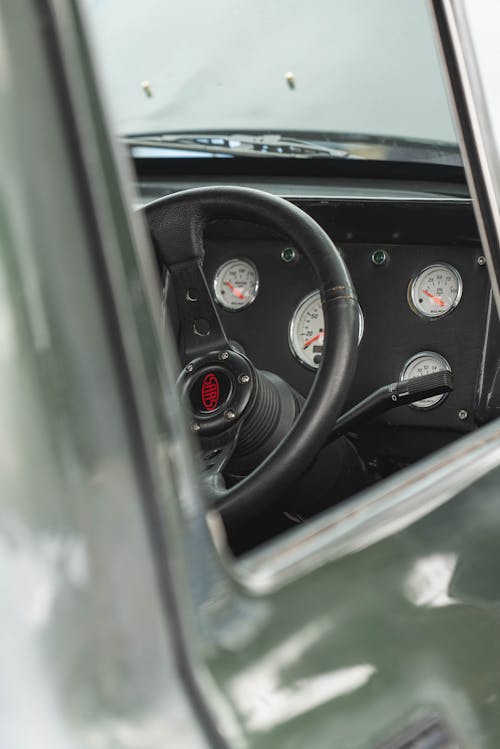 Photo of the Dashboard and Steering Wheel of a Retro Car