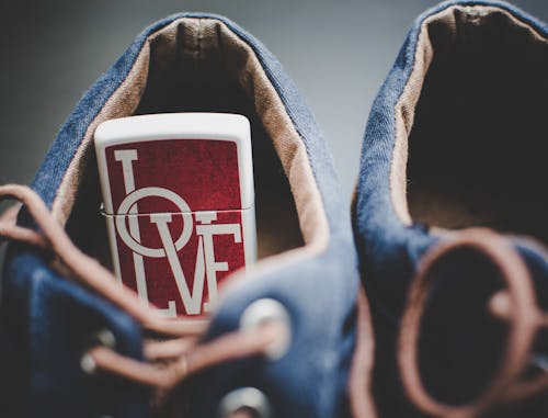 Free Red and White Love Flip Lighter in Shoe in Focus Photography Stock Photo