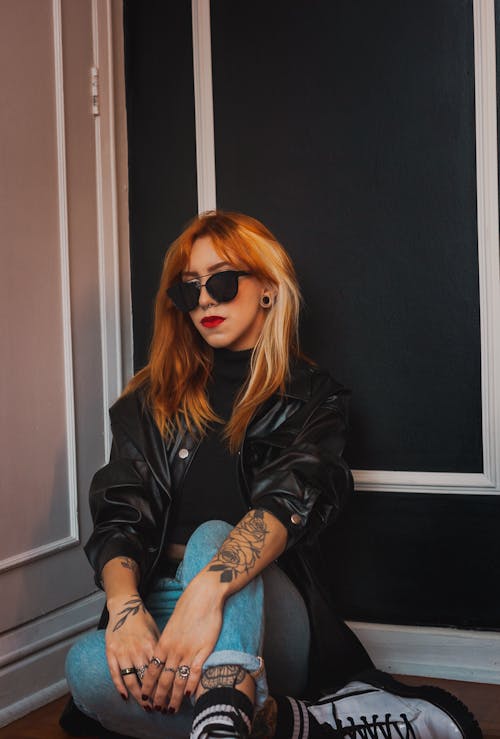 Woman in Black Leather Jacket and Blue Denim Jeans Wearing  Sunglasses