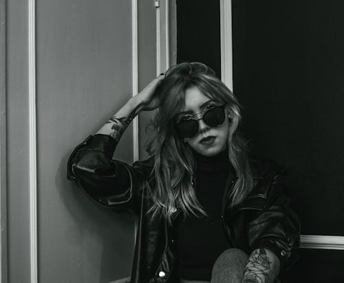 A Woman in Black Leather Jacket Wearing Black Sunglasses