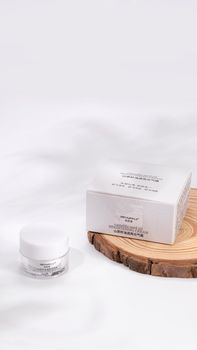 Minimalist white beauty product display on wood, highlighting luxury in skincare packaging.. minimalist, white, beauty