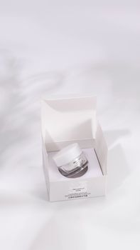 High-end skincare cream in an open white box with clean aesthetics and a focus on purity.