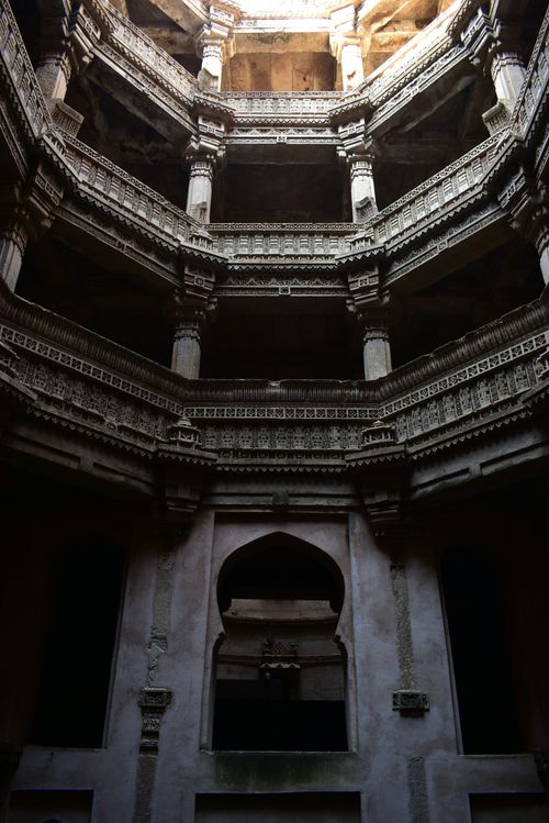 Free Explore the ancient and intricate design of a traditional Indian stepwell with ornate stone carvings. Stock Photo