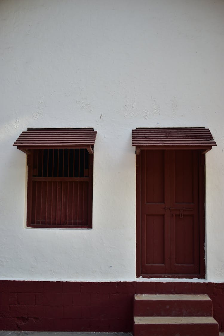 Wooden Painted Window And Door On A White Concrete Wall