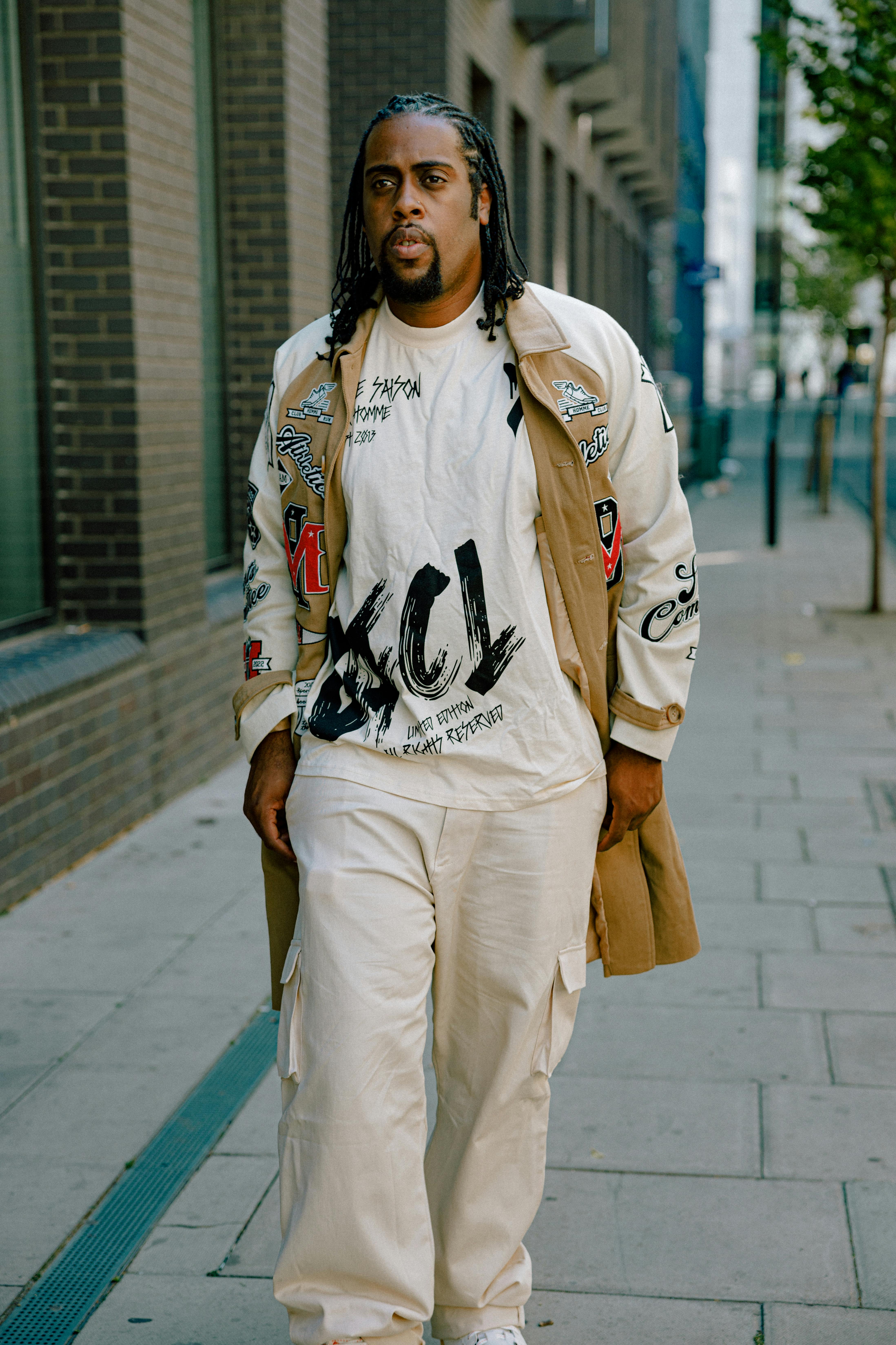 A person confidently walking down the street in an unusual outfit, surrounded by people with surprised and amused expressions.