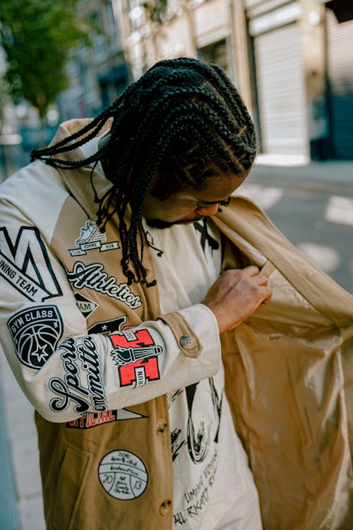 A Braided Haired Man in Printed Jacket Standing on the Street