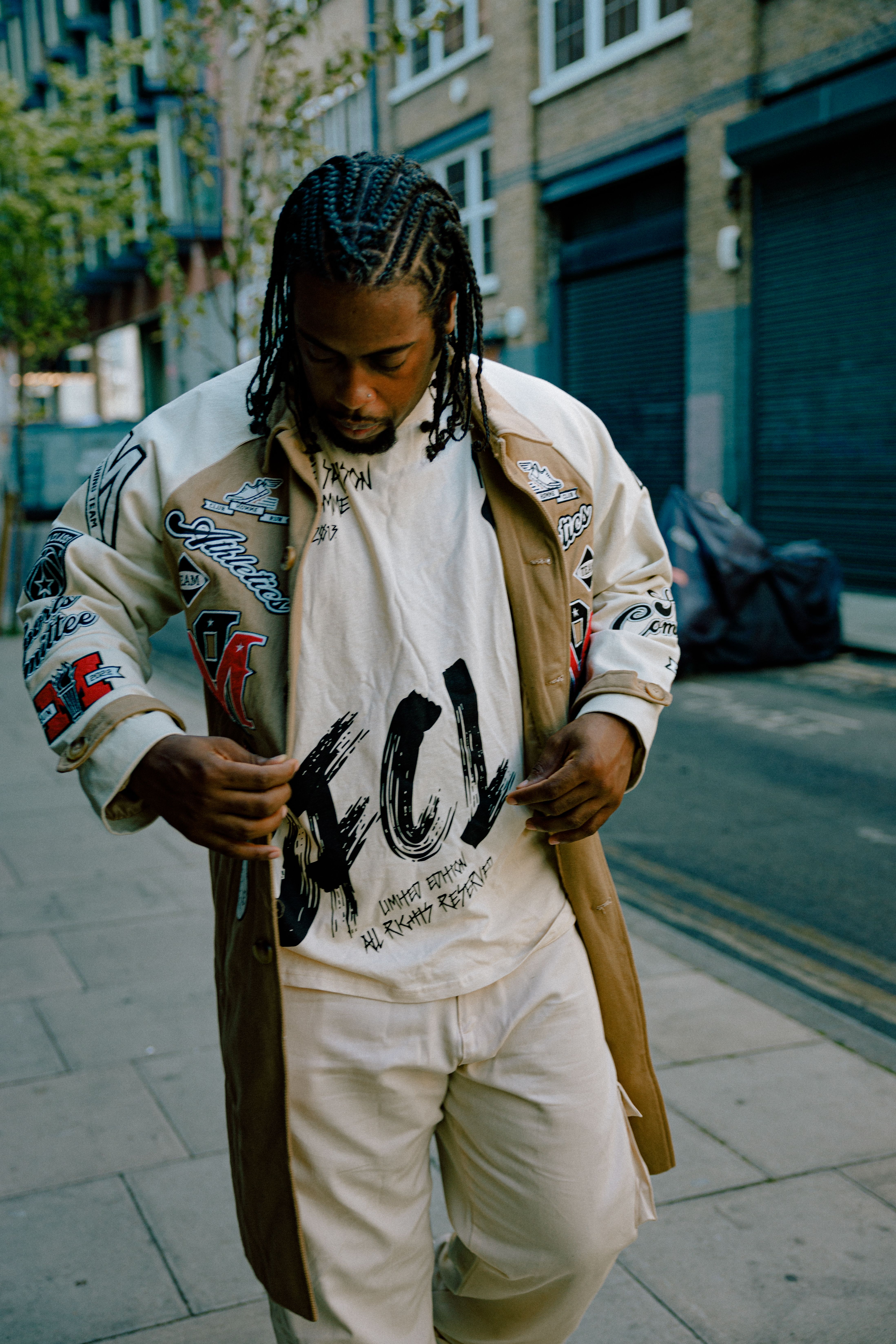 Stylish man in urban street setting showcasing modern streetwear fashion.