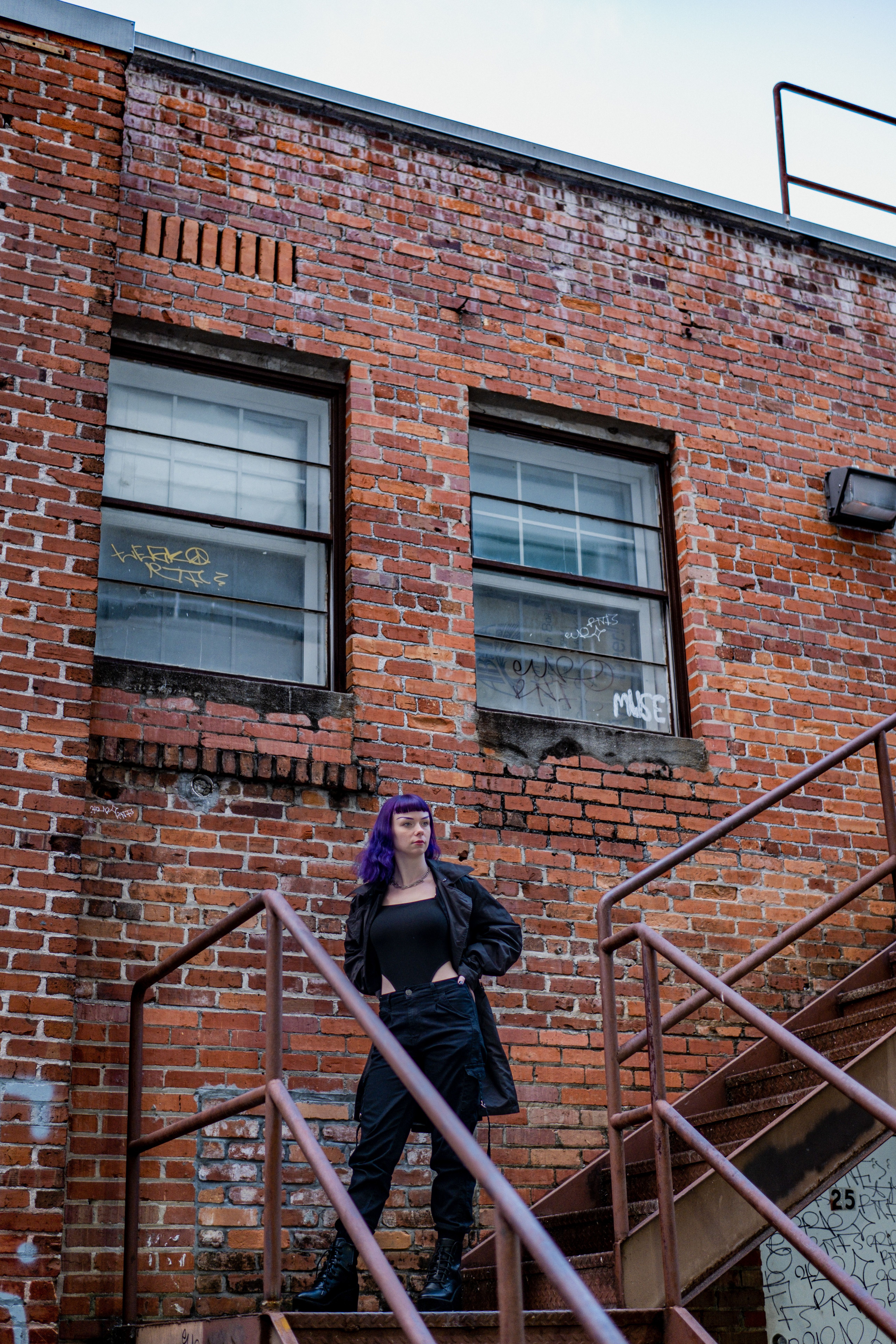 Woman in Black Jacket and Purple Hijab Standing on Stairs · Free Stock ...