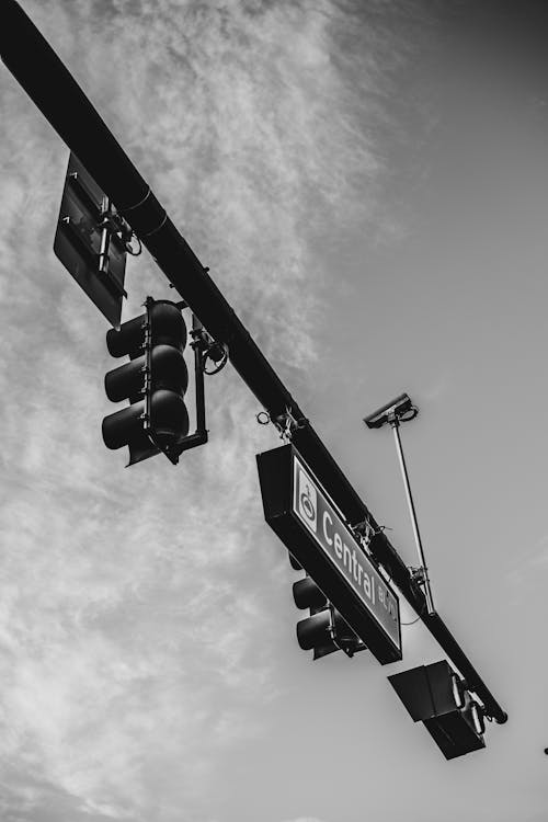 Grayscale Photo of Signage on a Traffic Light