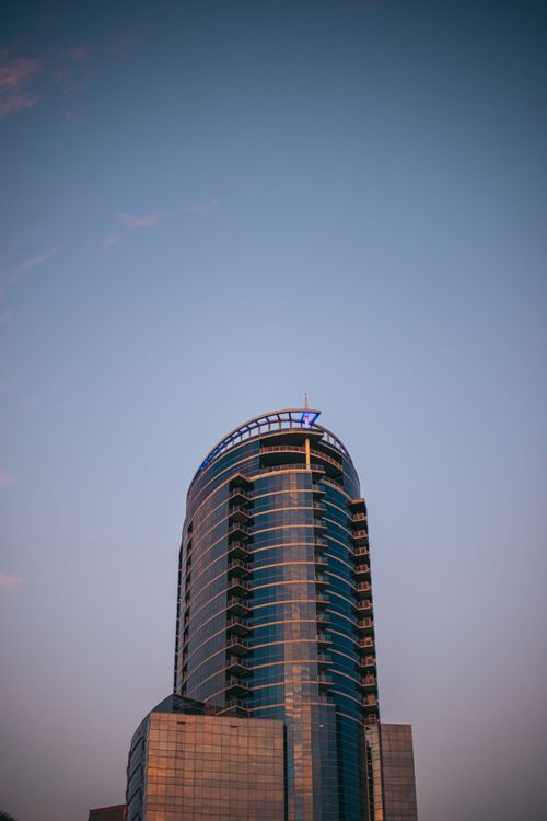 Free A sleek modern skyscraper against the twilight sky in downtown Orlando, Florida. Stock Photo