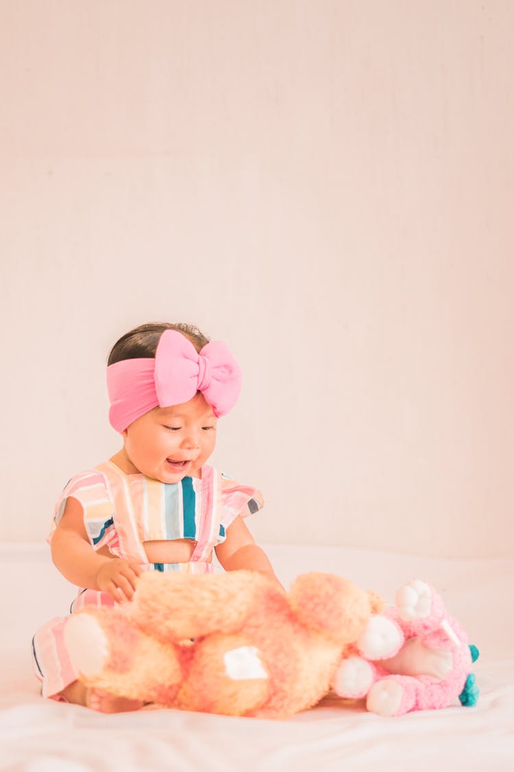 Cute Baby Girl Looking At Toys 