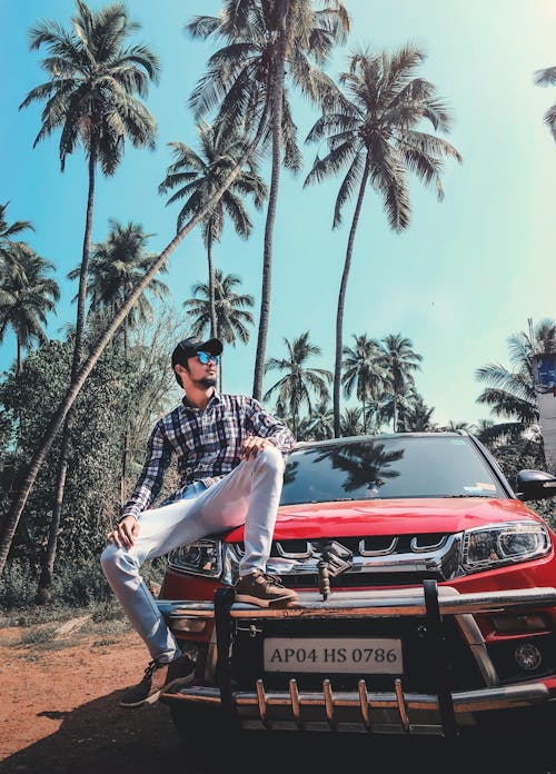 Man Sitting On A Suzuki Red Car