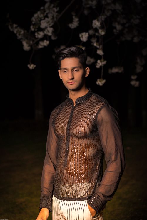 Free Fashion portrait of a young man posing outdoors in a stylish sheer shirt at night. Stock Photo