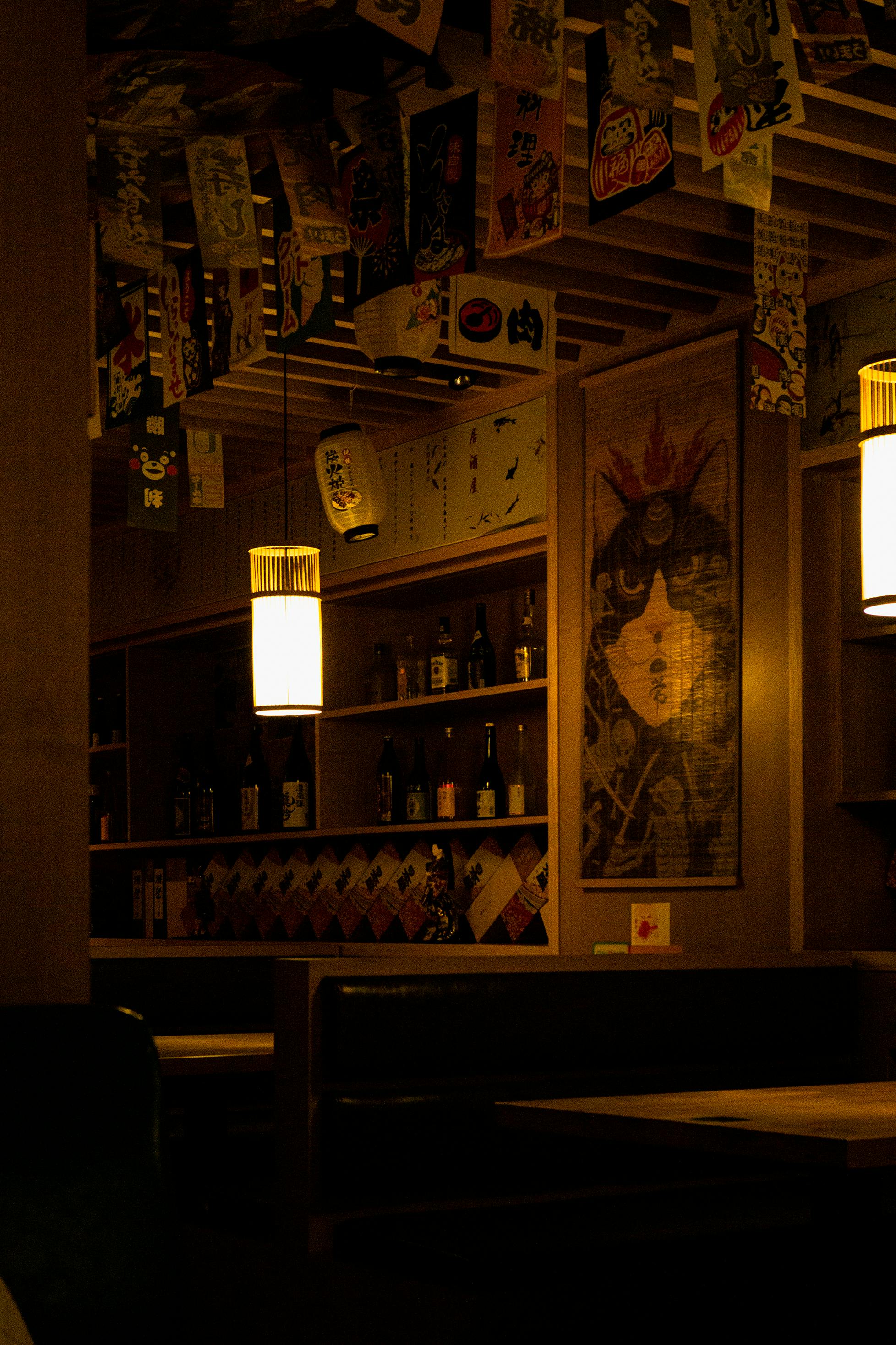 Interior of a private booth in a Japanese internet cafe, dimly lit