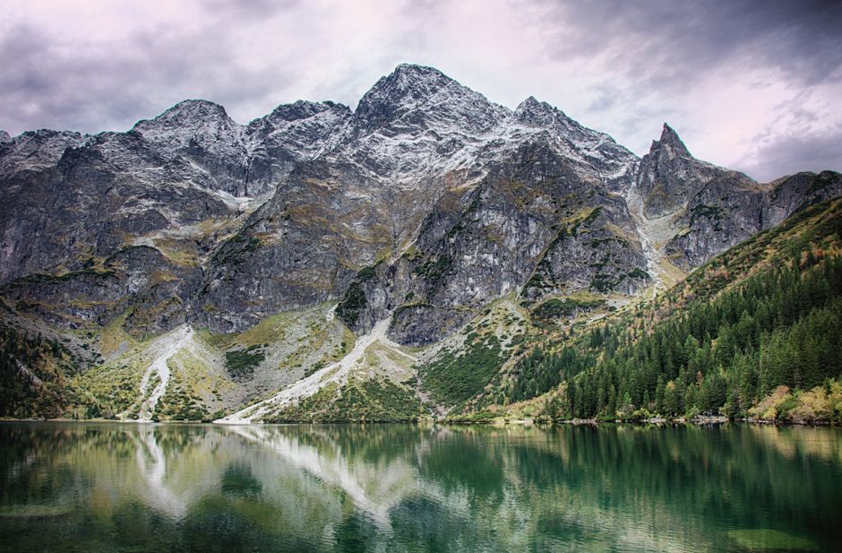 Serene mountain landscape reflecting in a tranquil lake, perfect for nature and travel themes.