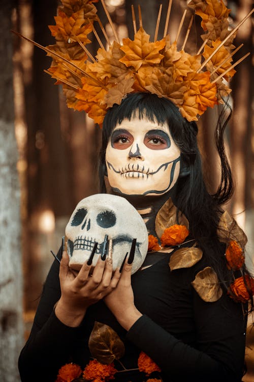Woman in Halloween Costume with Skull in Hands