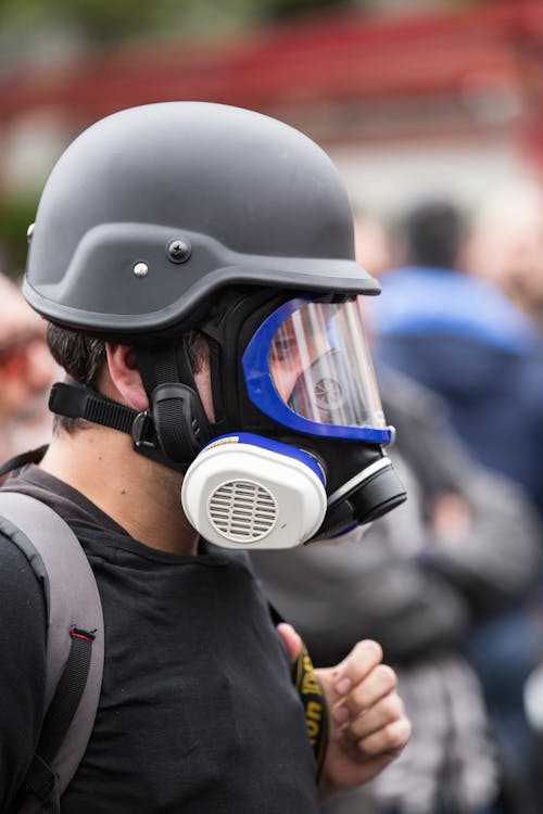 Man Wearing Black Gas Mask and Protective Helmet