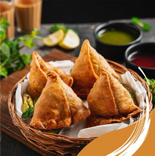 Free A tempting plate of crispy samosas with mint and tamarind chutney, perfect for a snack or appetizer. Stock Photo