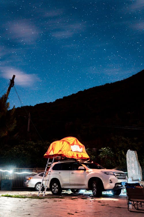 A White Car with a Rooftop Tent