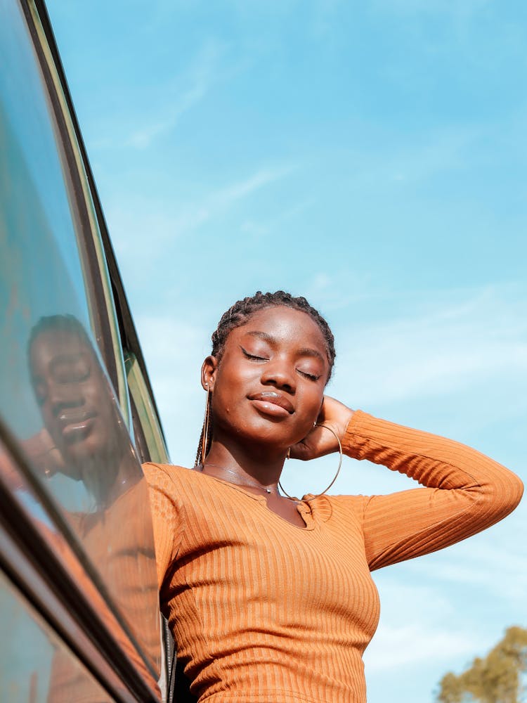 Photo Of A Woman Wearing Brown Sweater