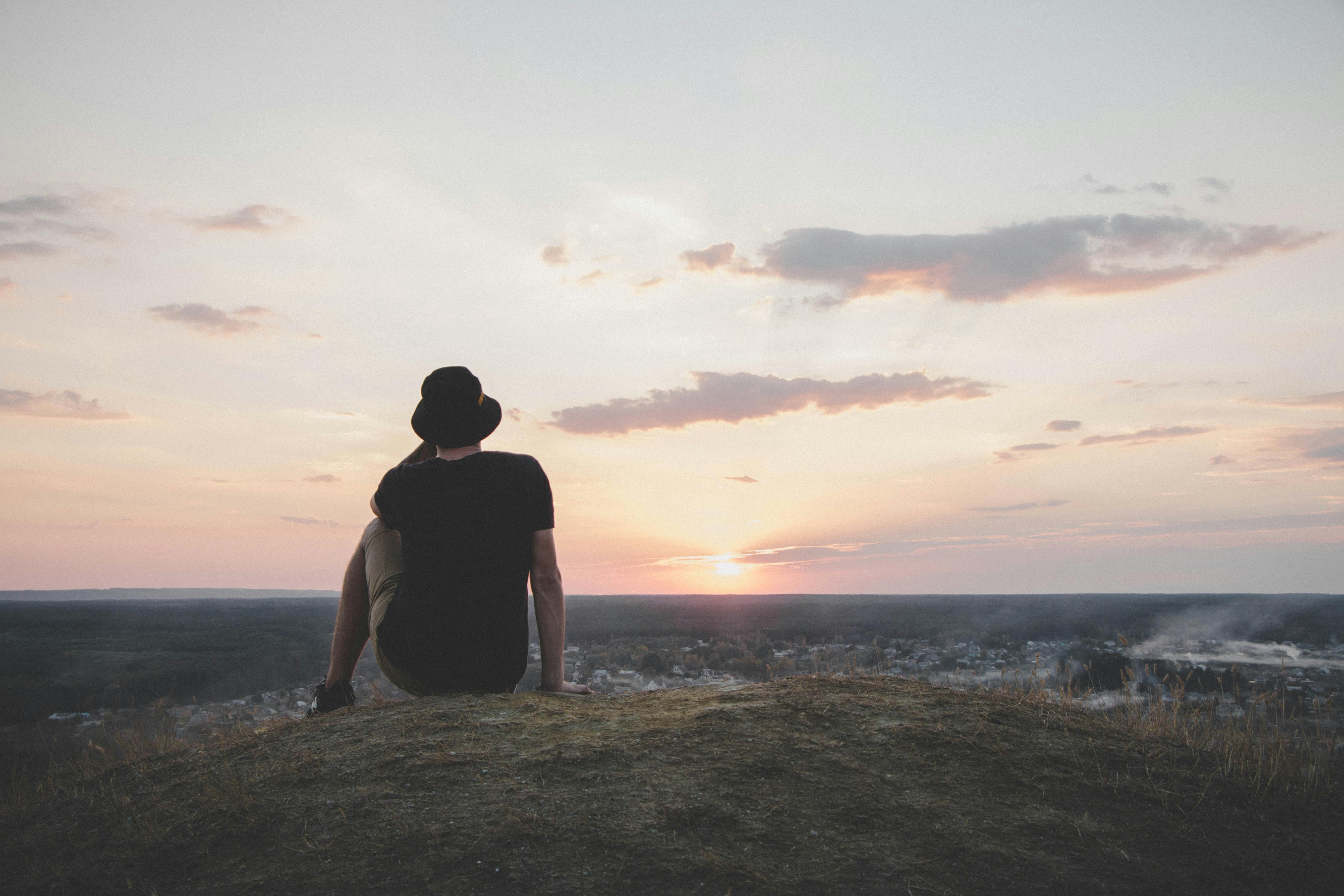 Person Sitting at Shoreline · Free Stock Photo