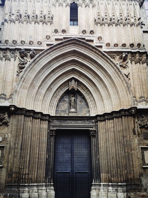 Free Detailed view of a gothic cathedral facade showcasing ornate stone work and sculptures. Stock Photo
