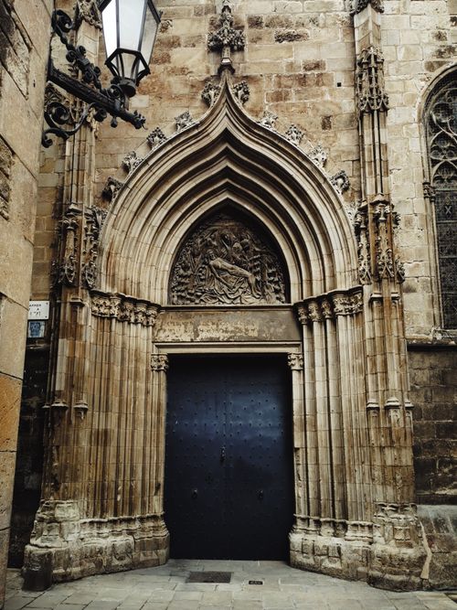 Free Intricate Gothic archway of a historic building with detailed stone carvings. Stock Photo