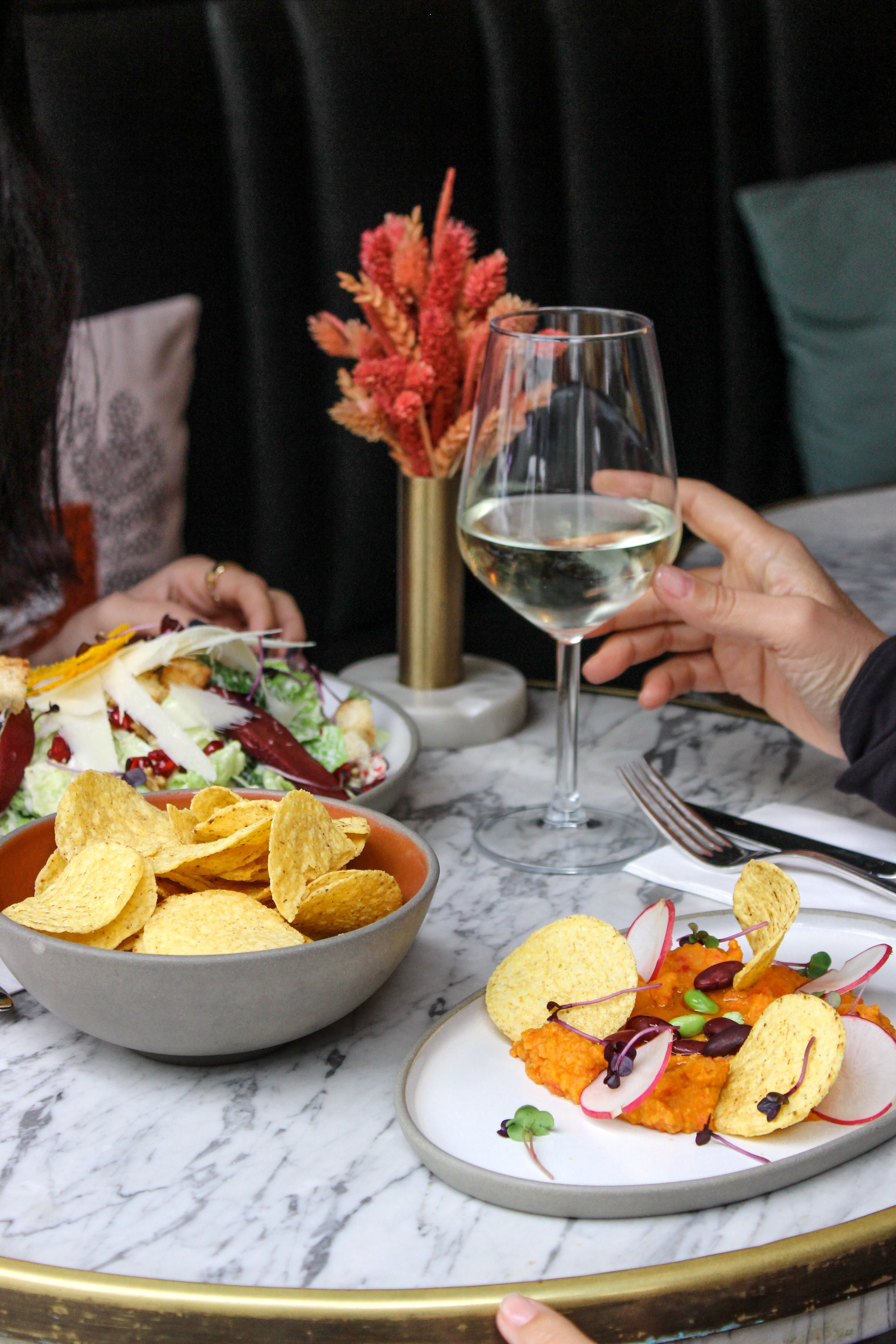 People at a Restaurant Eating and Drinking Wine · Free Stock Photo