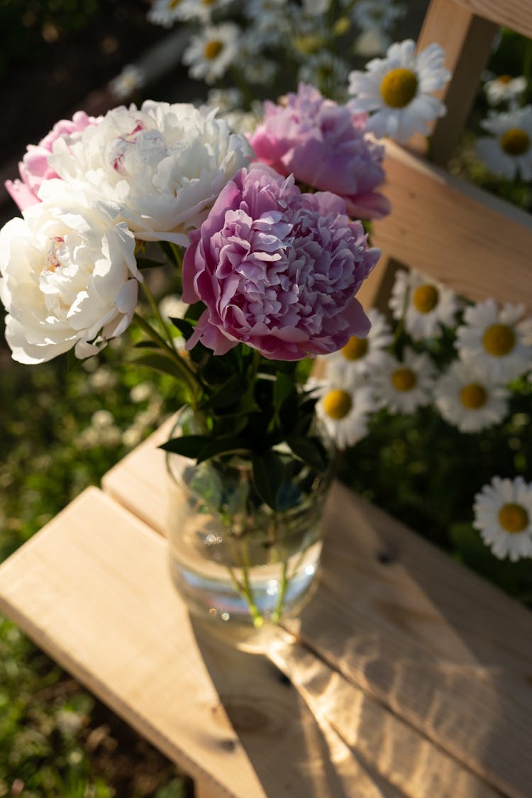 A Pink And White Flowers On Glass Vase