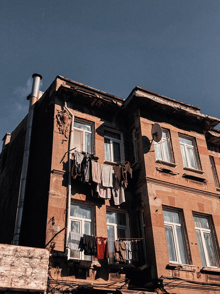 Clothes Hanging Outside Window Of A House