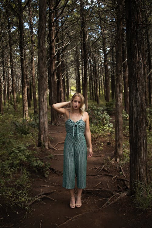 Woman Standing in the Middle of a Forest