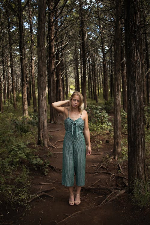 Free Woman Standing in the Middle of a Forest Stock Photo
