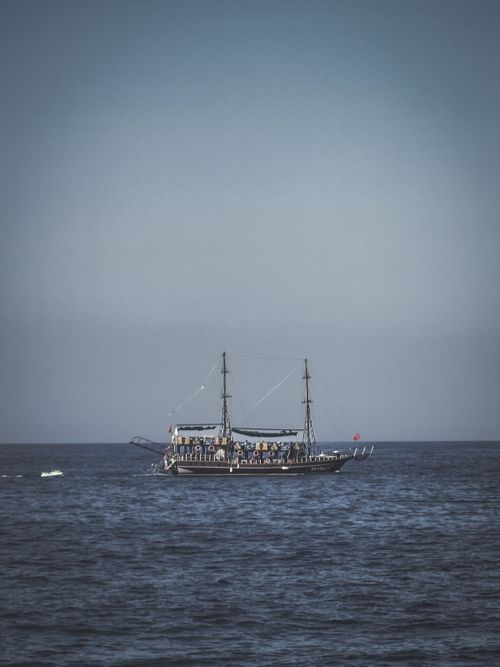Free A historic ship sails on a calm ocean under a blue sky, offering a serene seascape. Stock Photo
