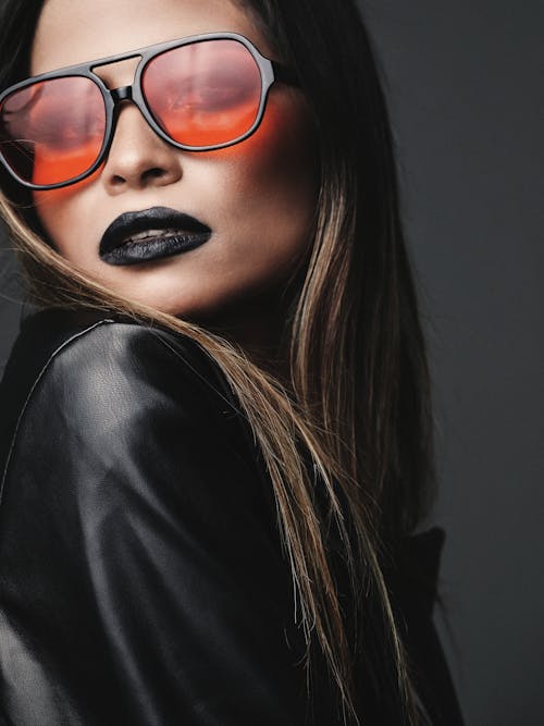 Free Woman Wearing Black Sunglasses and Black Leather Jacket Stock Photo