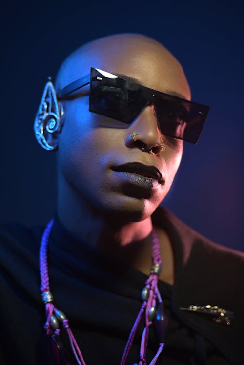 Woman Wearing Black Sunglasses and Purple Beaded Necklace