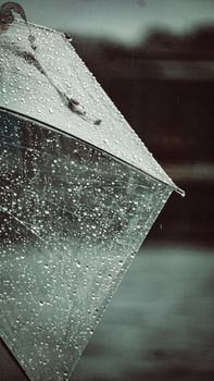 Detailed shot of a transparent umbrella covered in raindrops, reflecting the rainy ambiance of Istanbul.