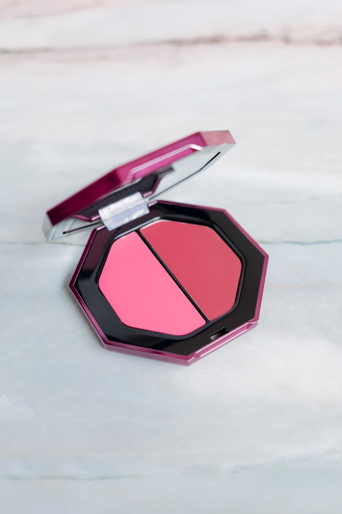 Open blush compact with two pink shades on a pale marble surface — photo by Alena Chuyankova on Pexels