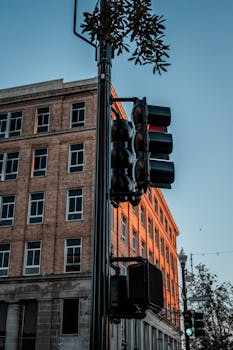 Street corner with traffic lights and brick building in the evening light. Urban scene.