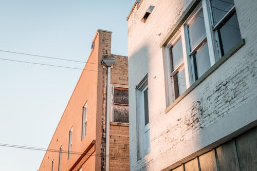 Brown and White Concrete Buildings with Glass Windows 