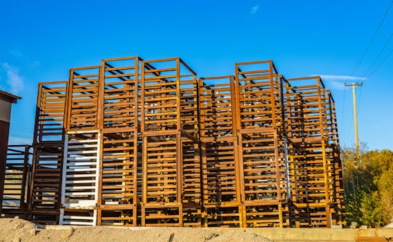 Rusty steel framework for construction, set against a clear blue sky.
