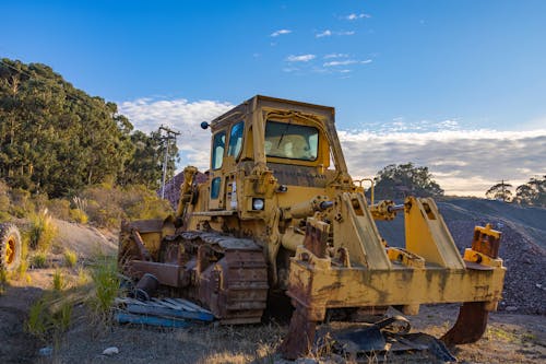 Yellow and Black Heavy Equipment on Dirt Ground